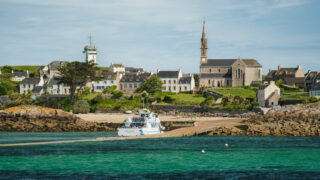Vue sur le village et le phare de l’île de Batz depuis la mer, Finistère nord